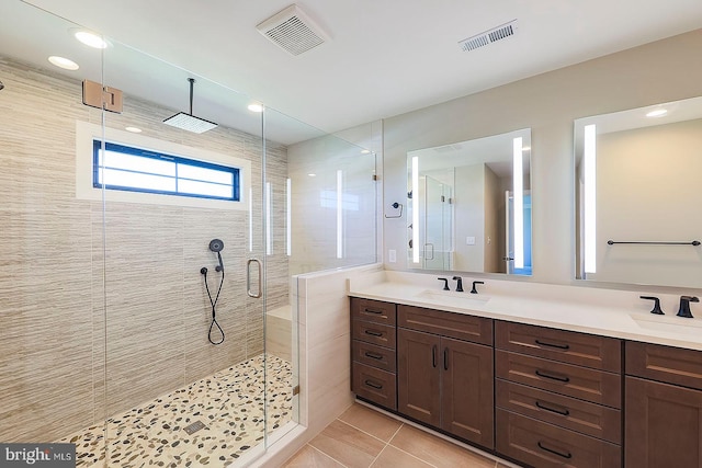 bathroom with vanity, tile patterned floors, and a shower with door