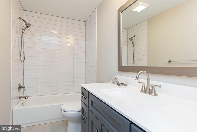 full bathroom with tile patterned floors, toilet, tiled shower / bath combo, and vanity