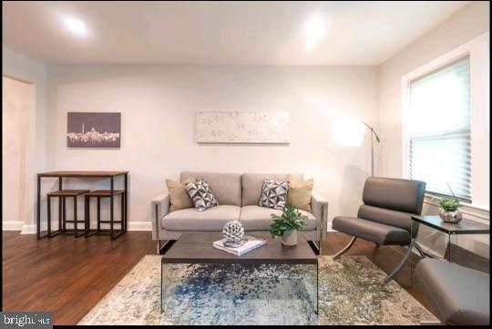 living room with dark hardwood / wood-style flooring