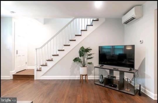 living room with dark hardwood / wood-style flooring and a wall mounted AC