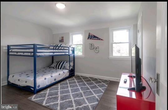 bedroom featuring dark hardwood / wood-style flooring and multiple windows