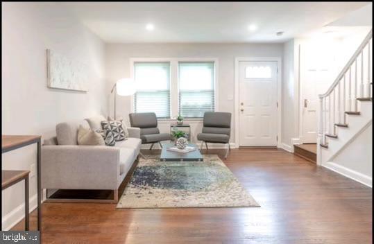 living room with dark hardwood / wood-style floors