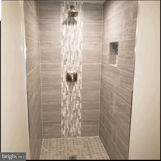 bathroom with tiled shower