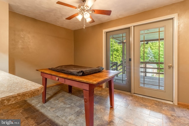 interior space with ceiling fan