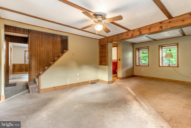 interior space with beamed ceiling, carpet floors, and ceiling fan