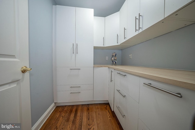 kitchen with white cabinetry and dark wood-type flooring