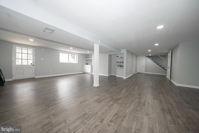 basement with dark hardwood / wood-style flooring