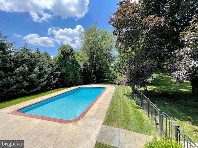 view of swimming pool with a lawn