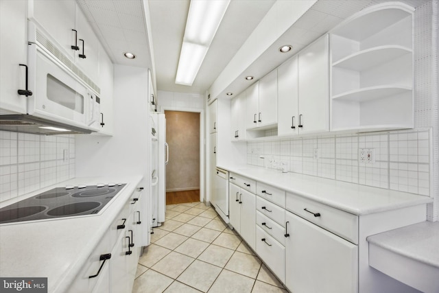 kitchen featuring decorative backsplash, white appliances, and white cabinetry