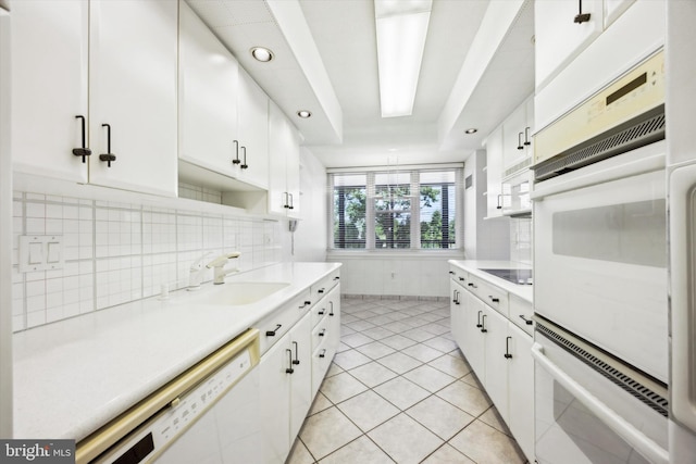 kitchen with white appliances and white cabinetry