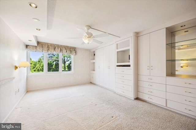 unfurnished bedroom featuring light carpet and ceiling fan