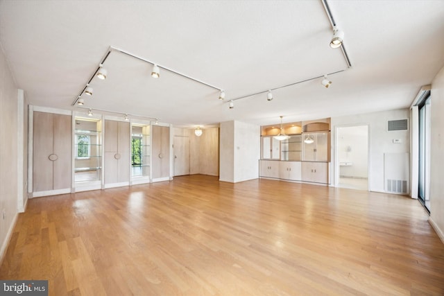 unfurnished living room with light hardwood / wood-style floors