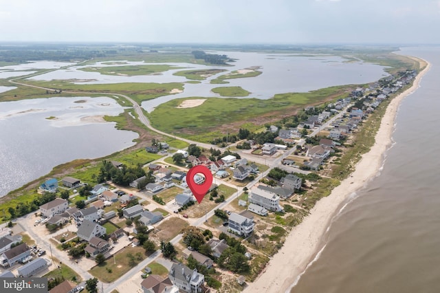 aerial view with a water view and a view of the beach