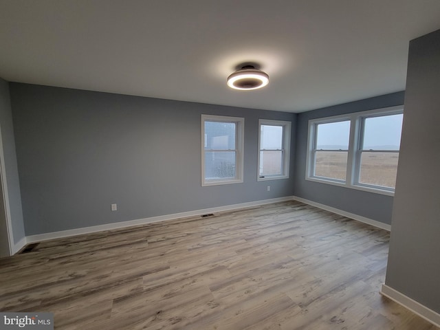 spare room with light hardwood / wood-style floors