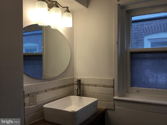 bathroom with sink and tile walls