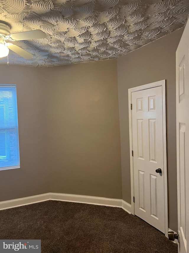 spare room with ceiling fan and carpet floors