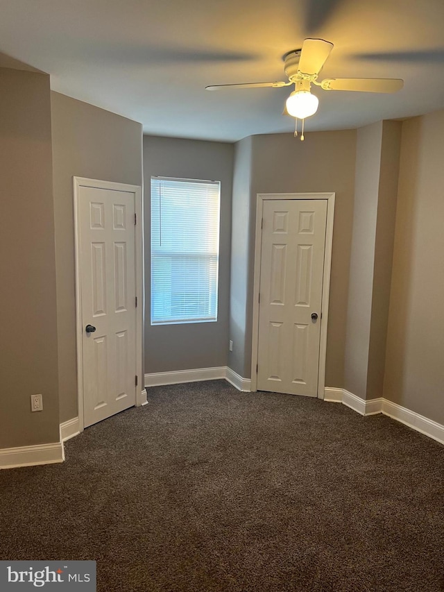 carpeted spare room featuring ceiling fan