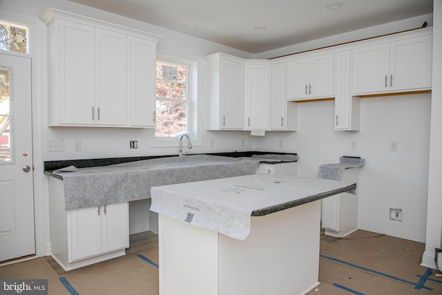 kitchen with white cabinets and a center island