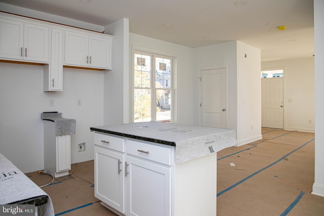 kitchen with white cabinetry and a center island