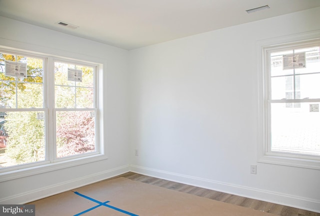 spare room with wood-type flooring