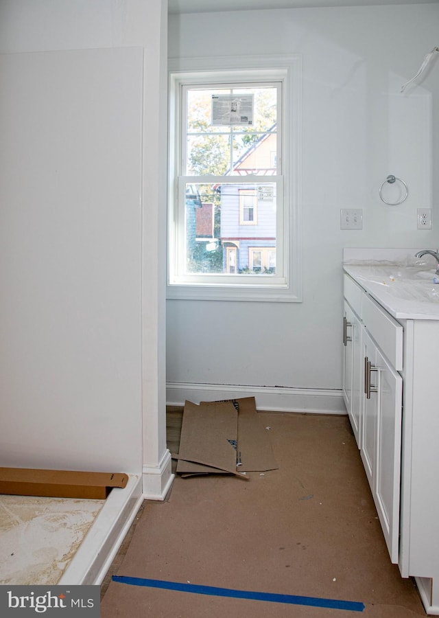 bathroom with vanity and baseboards