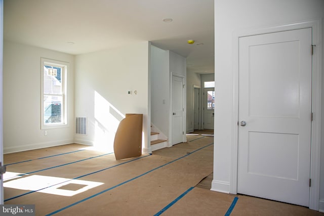 interior space featuring stairway, visible vents, and baseboards