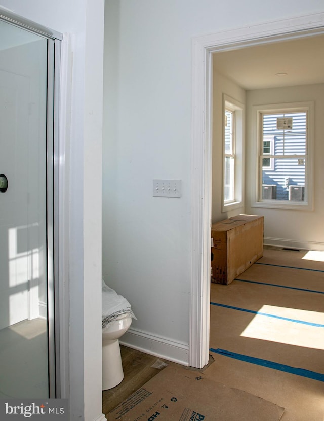 bathroom featuring toilet and wood-type flooring