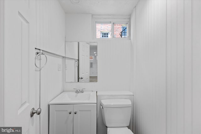 bathroom with vanity, toilet, and a textured ceiling