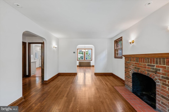 unfurnished living room with a fireplace and hardwood / wood-style flooring