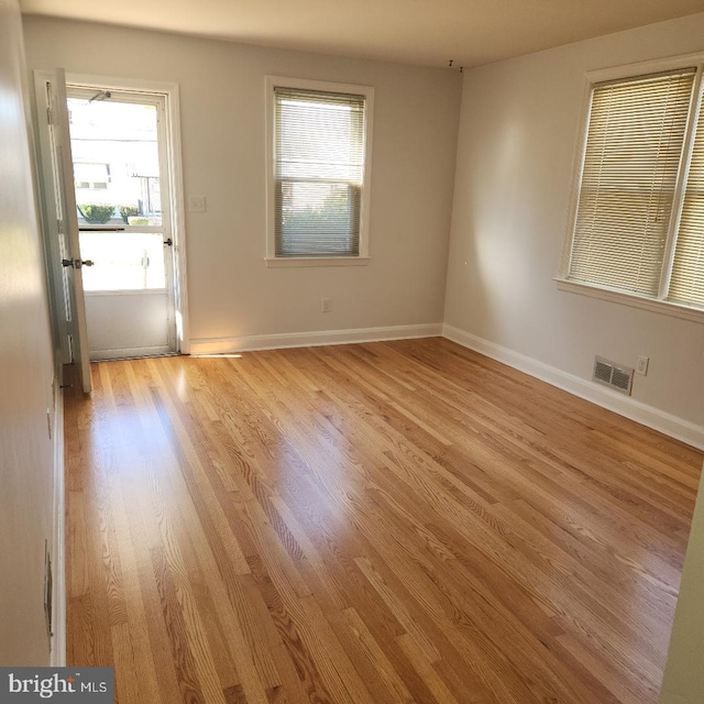 unfurnished room with light hardwood / wood-style flooring