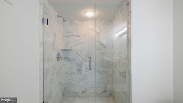 bathroom with a shower with shower door