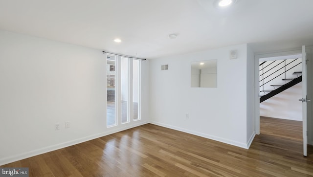 empty room with hardwood / wood-style flooring