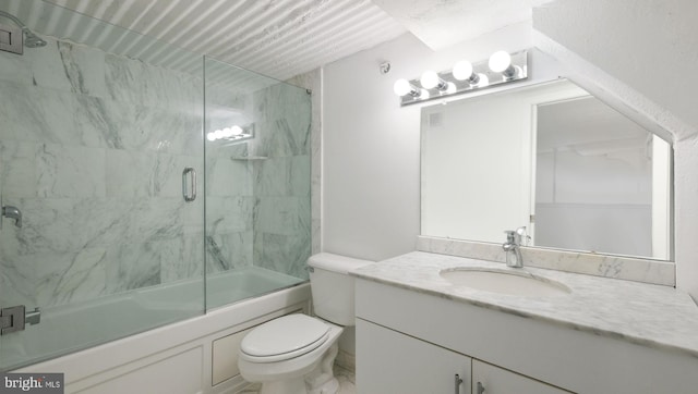 full bathroom with shower / bath combination with glass door, vanity, and toilet