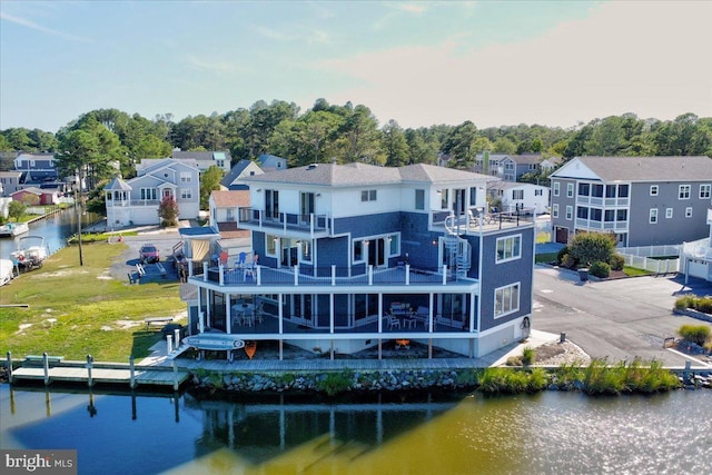 back of house with a balcony and a water view