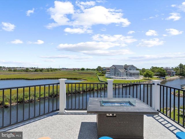 view of patio / terrace featuring a balcony and a water view