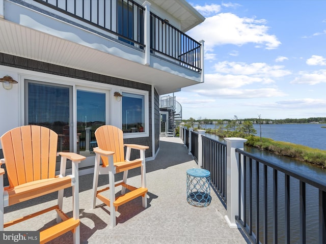 view of patio / terrace featuring a balcony and a water view