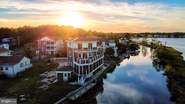 view of dock featuring a balcony and a water view