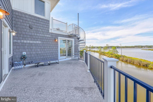 view of patio / terrace featuring a balcony and a water view