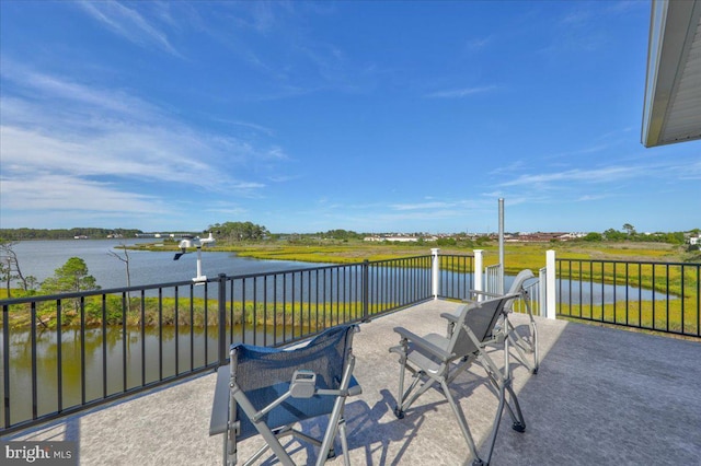 view of patio / terrace with a balcony and a water view