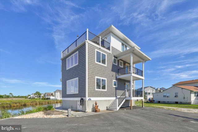 exterior space with a balcony and a water view