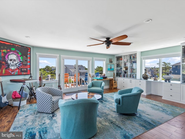 living room with hardwood / wood-style flooring and ceiling fan