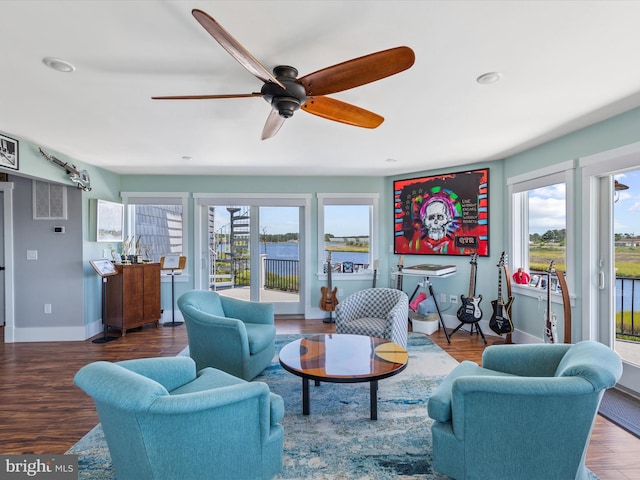 living room with ceiling fan and dark hardwood / wood-style floors