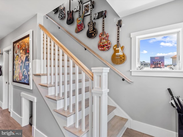 staircase with hardwood / wood-style floors