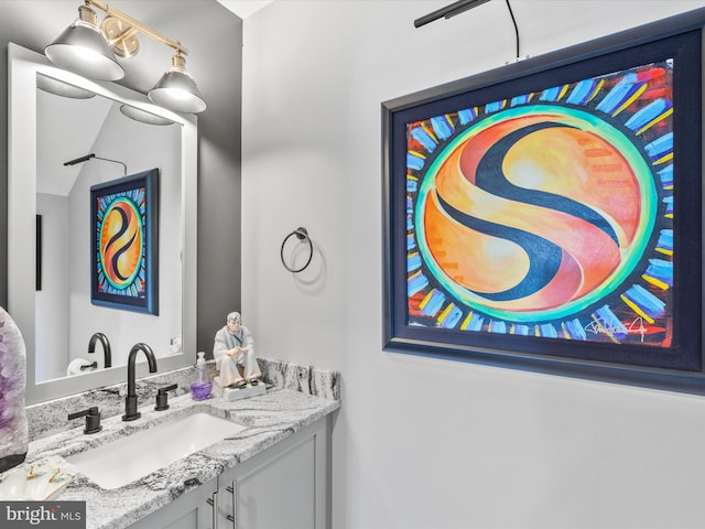 bathroom with vanity and vaulted ceiling