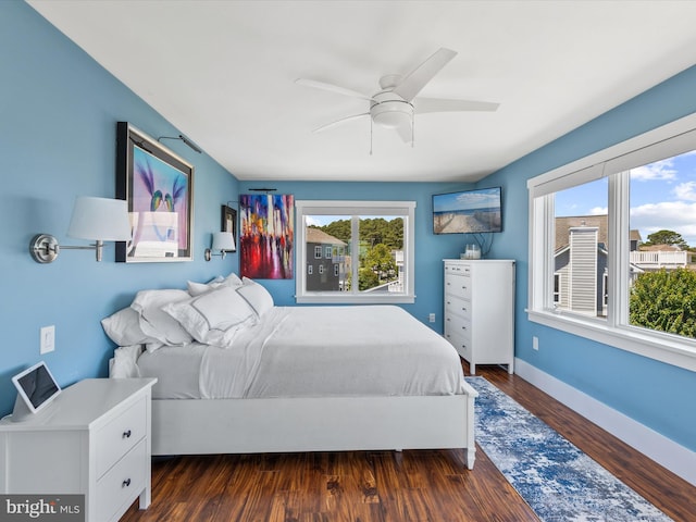 bedroom with ceiling fan and dark hardwood / wood-style flooring