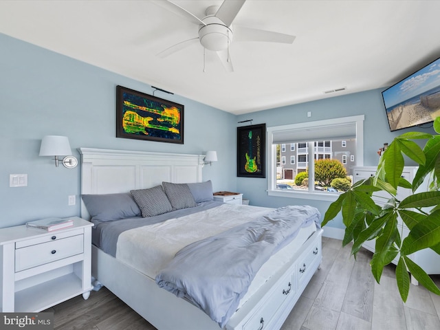 bedroom with ceiling fan and light hardwood / wood-style floors