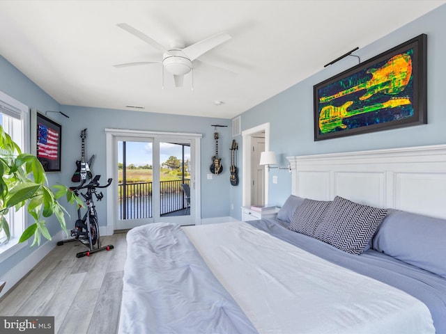 bedroom featuring access to outside, ceiling fan, and light hardwood / wood-style floors