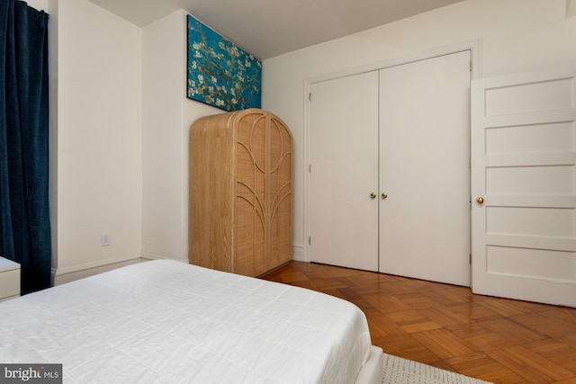 bedroom with a closet and parquet floors