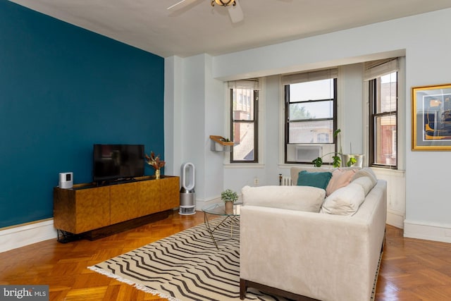 living room with ceiling fan and parquet flooring