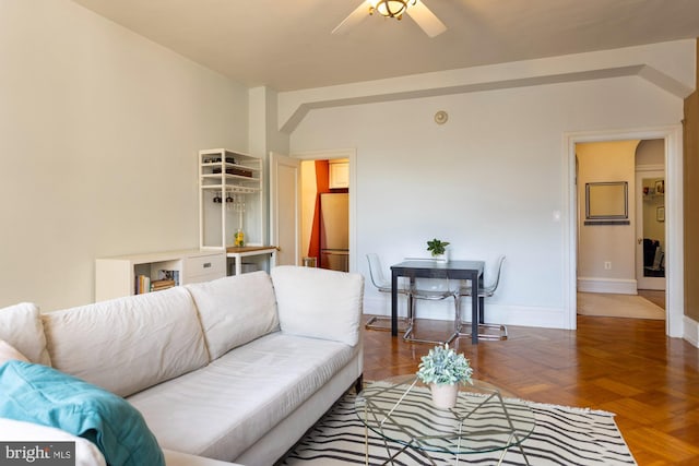 living room with ceiling fan and parquet floors